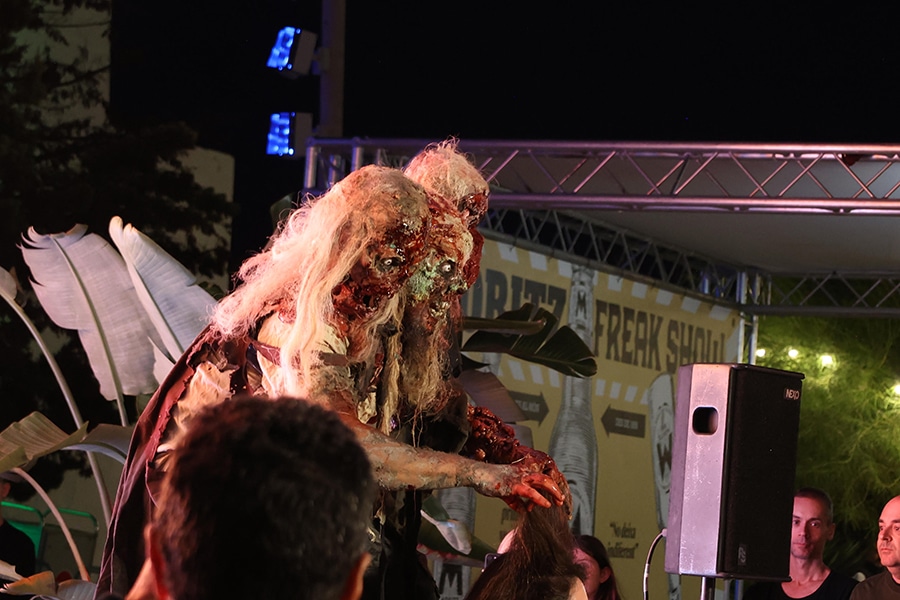 imatge home disfrassat amb 3 caps de zombi, a Sitges, Festival Cine de Terror